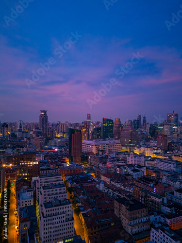 defaultAerial view of modern city skyline and burning clouds at sunrise in Shanghai.