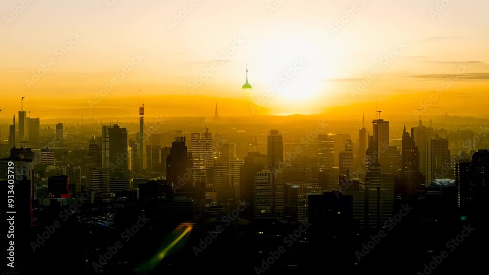 Wide shot: Silhouetted skyline against vibrant sunset. Golden light bathes city, creating dynamic interplay of light and shadow across skyscrapers and urban structures. Wide shot: Silhouetted skyline against vibrant sunset. Golden light bathes city, creating dynamic interplay of light and shadow across skyscrapers and urban structures.