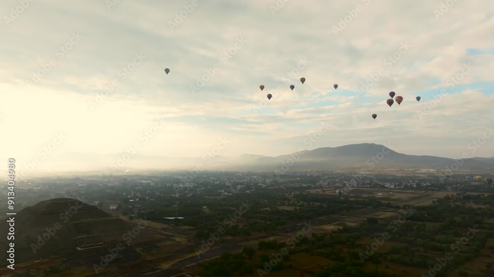 Morning adventure near Toetihuacan with hot air balloons flying atop Pyramid of the Sun. Orbit drone aerial Morning adventure near Toetihuacan with hot air balloons flying atop Pyramid of the Sun. Orbit drone aerial