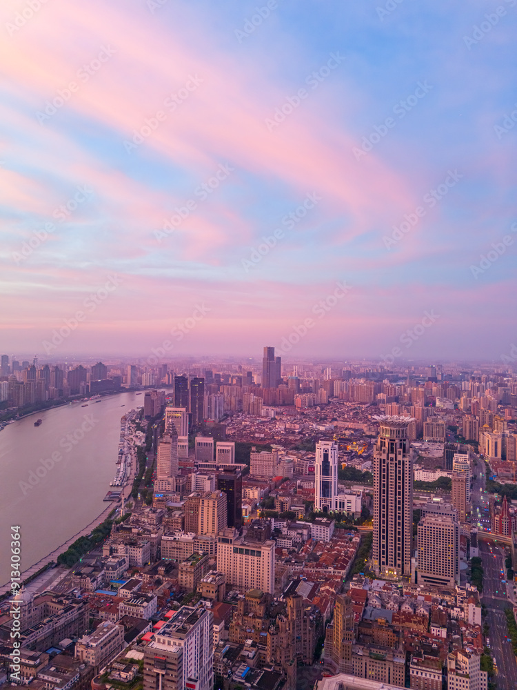Fototapeta premium Aerial view of modern city skyline and burning clouds at sunrise in Shanghai.