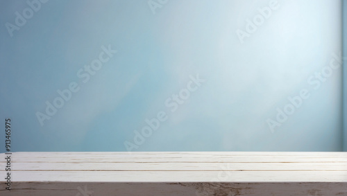The empty white wooden table top with blur background of pastel blue walls