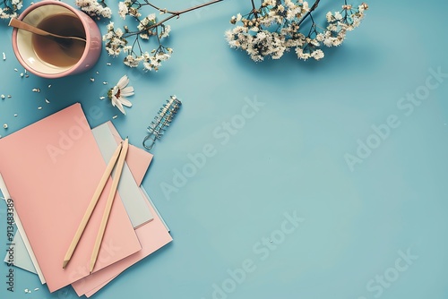 Creative flat lay of stationery on a blue background with space for text, professional color grading, soft shadows.