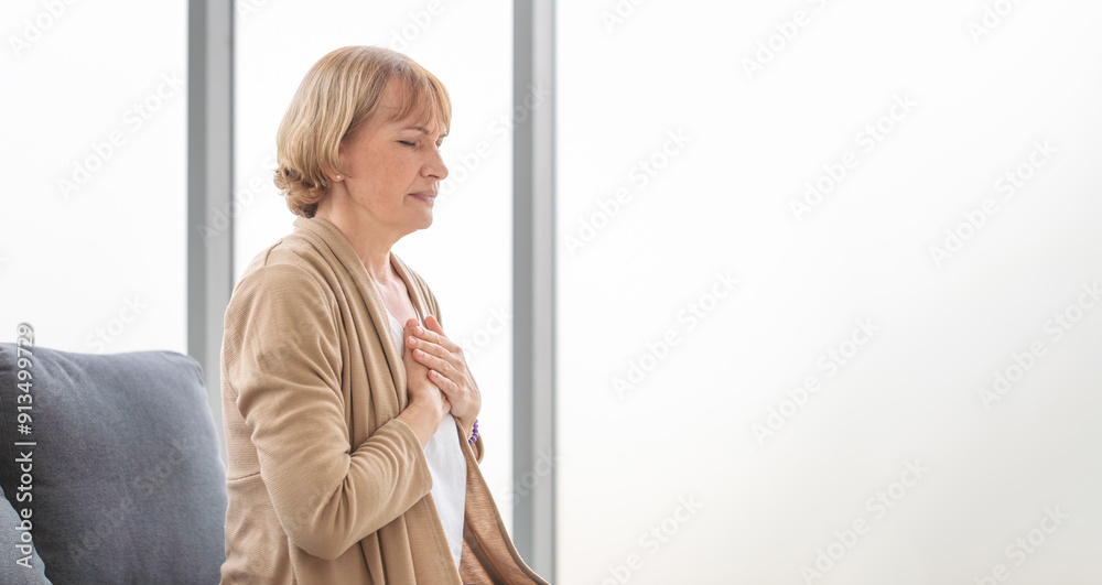 Woman with pain on heart, Mature female presses hand to chest has heart attack suffers from unbearable pain Woman with pain on heart, Mature female presses hand to chest has heart attack suffers from unbearable pain