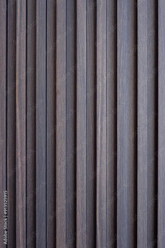 Wood battens wall straight line background texture. Architecture indoor and outdoor material in brown color. Wood battens wall straight line background texture. Architecture indoor and outdoor material in brown color.
