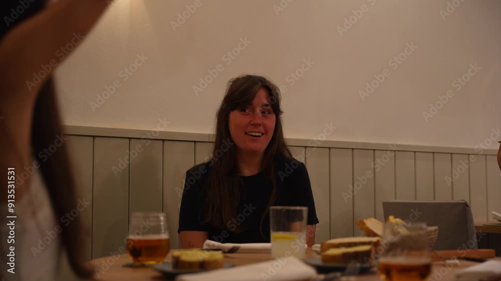 Friends laughing happily while talking and making gestures eating in restaurant. Close up, static Friends laughing happily while talking and making gestures eating in restaurant. Close up, static