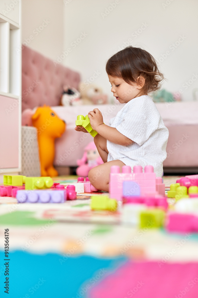 cute baby girl playing with colorful toys bricks in white bedroom cute baby girl playing with colorful toys bricks in white bedroom