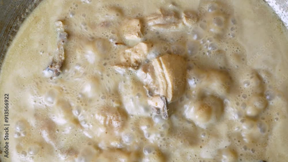 top view of Opor Ayam (Indonesian chicken and beef curry) in the making, a popular traditional indonesian dish top view of Opor Ayam (Indonesian chicken and beef curry) in the making, a popular traditional indonesian dish