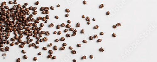 Scattered coffee beans on white surface, space for text