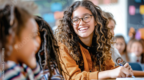 Happy female teacher assisting her student during a class at elementary school.