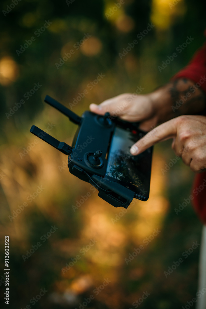 Couple using a drone during the hiking in the forest Couple using a drone during the hiking in the forest