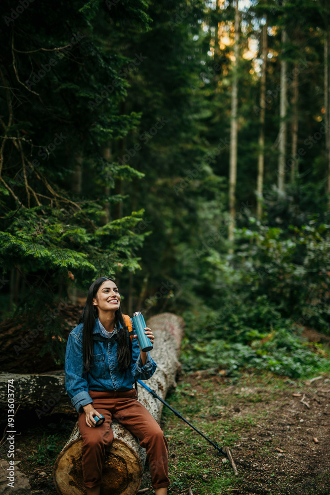 Smiling hiker enjoying day in the nature, sitting and taking a rest after a hike admiring nature Smiling hiker enjoying day in the nature, sitting and taking a rest after a hike admiring nature