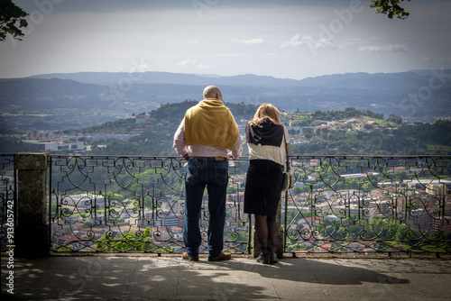 Принти на полотні An old couple looking into the mountain landscape, with their backs turned away from the camera