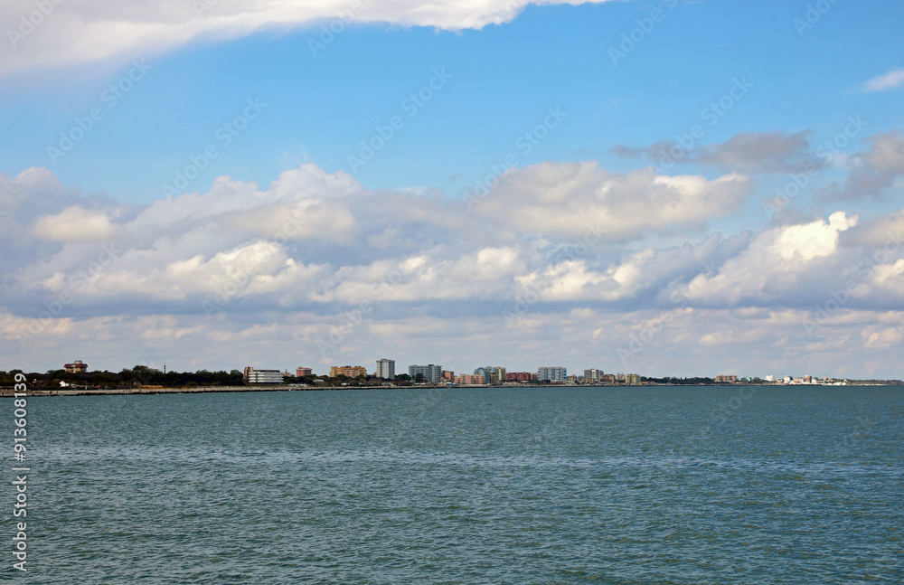 condominiums and hotels on the sea shore in the distance to accommodate tourists during the summer season condominiums and hotels on the sea shore in the distance to accommodate tourists during the summer season
