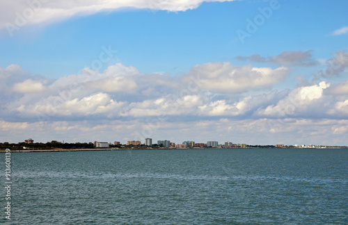 condominiums and hotels on the sea shore in the distance to accommodate tourists during the summer season