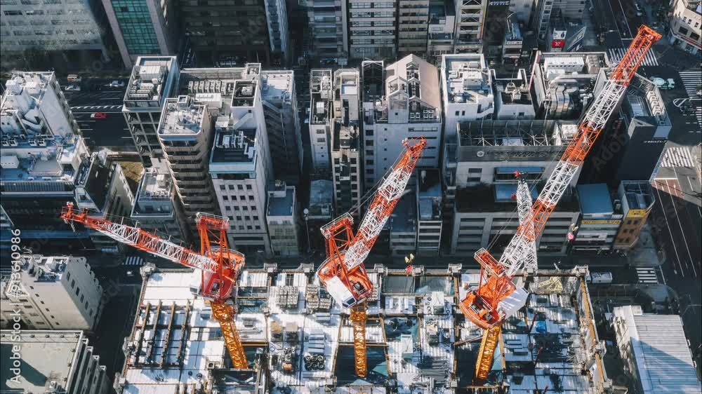 A city skyline with a crane in the middle. The crane is orange and white. The city is busy and bustling A city skyline with a crane in the middle. The crane is orange and white. The city is busy and bustling