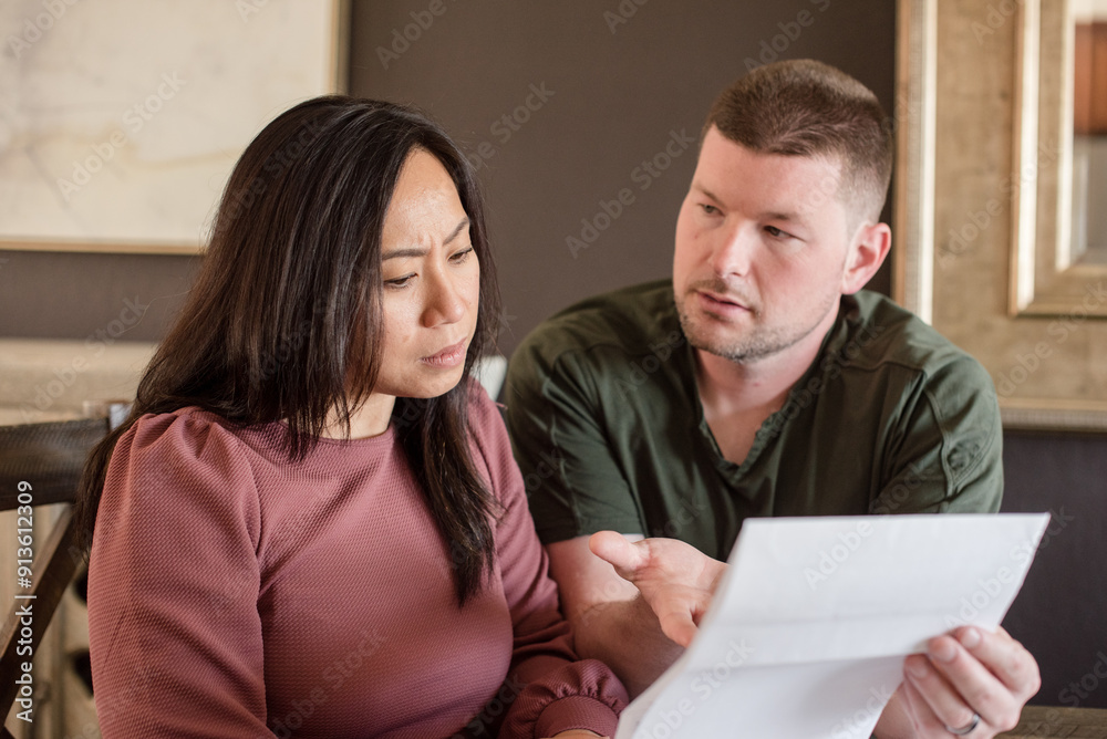 Mixed Couple going over bills Mixed Couple going over bills