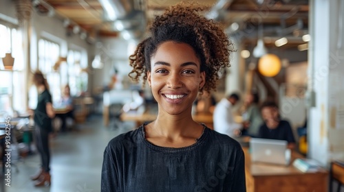 Young Professional Smiling in Modern Office Space With Collaborative Atmosphere
