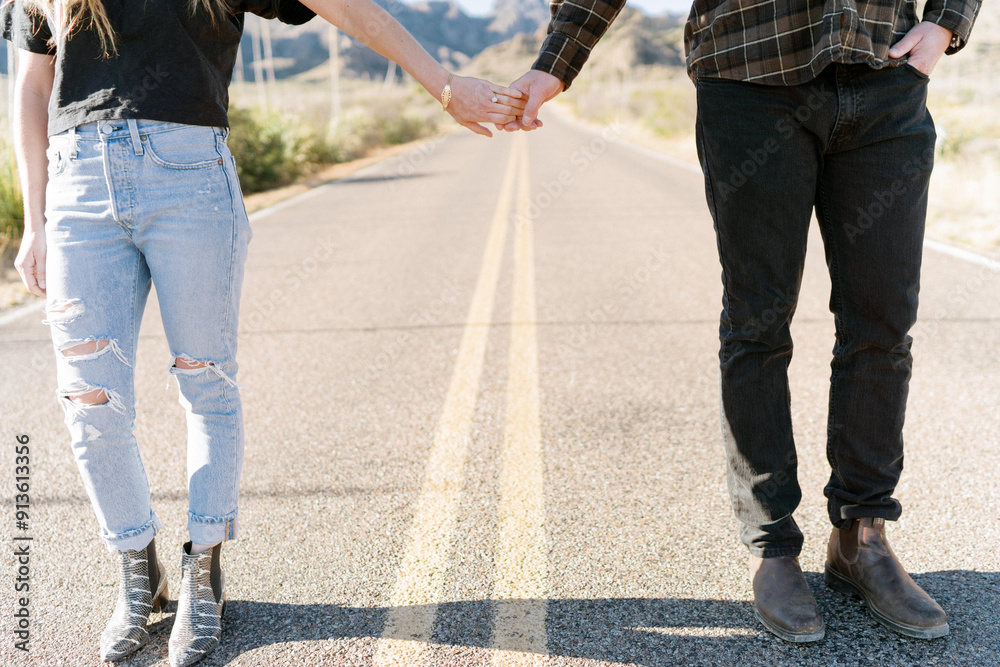 A man and woman holding hands on a road that leads to the Chisos A man and woman holding hands on a road that leads to the Chisos