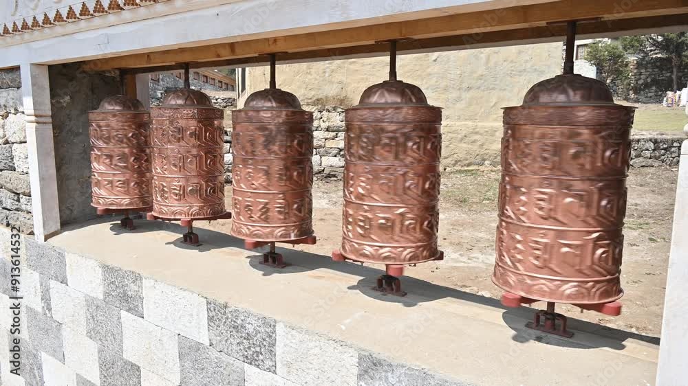 Rows of bronze prayer wheel in Buddhist temple in Kathmandu city of Nepal. The words mantra Rows of bronze prayer wheel in Buddhist temple in Kathmandu city of Nepal. The words mantra