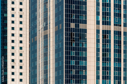 many windows and walls facade of a modern skyscraper without people