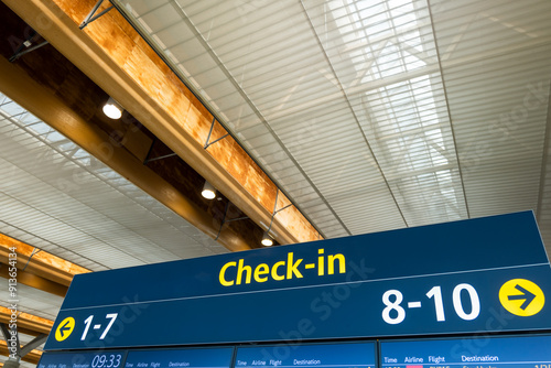  Airport flight boarding information screen and check-in counter sign in airport
