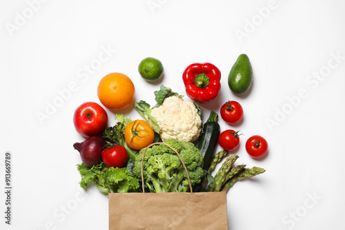 Fototapeta Naklejka Na Ścianę i Meble -  Delivery of vegetarian products. Bag with different vegetables and fruits on white background, top view