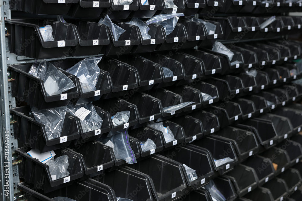 Obraz premium Many plastic boxes for storing car parts in auto store