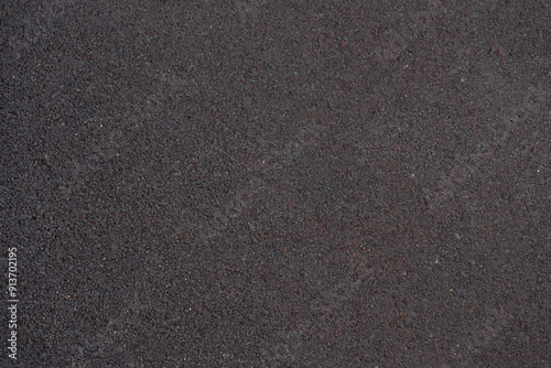gray background, texture of rubber crumb coating for sports and children's playgrounds, paths