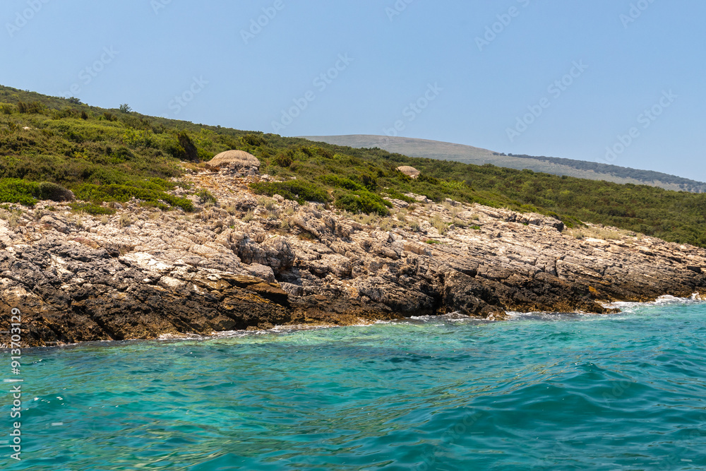 The peninsula Karaburun in Albania near the city of Vlore. A touristic hotspots for daytrips to swim in the crystal clear waters and it marks the border between the Adriatic and Ionian seas The peninsula Karaburun in Albania near the city of Vlore. A touristic hotspots for daytrips to swim in the crystal clear waters and it marks the border between the Adriatic and Ionian seas