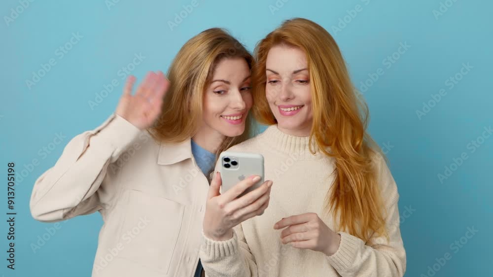 Selfie, pose, friends, and fashionable woman with phone, peace sign for social media post. Two women sister with mobile smartphone posing, taking profile picture, trendy makeup outfit, blue background Selfie, pose, friends, and fashionable woman with phone, peace sign for social media post. Two women sister with mobile smartphone posing, taking profile picture, trendy makeup outfit, blue background