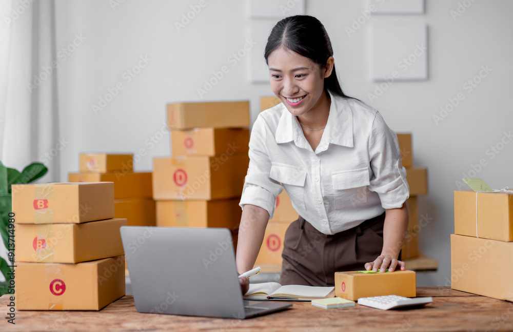 Sme Female ecommerce business owner prepares package box for customer and delivery check balance. asian SME, SME business ideas online. Sme Female ecommerce business owner prepares package box for customer and delivery check balance. asian SME, SME business ideas online.