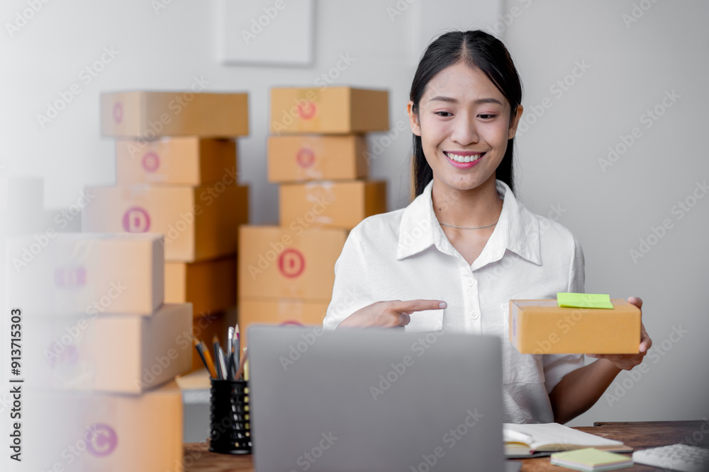Sme Female ecommerce business owner prepares package box for customer and delivery check balance. asian SME, SME business ideas online. Sme Female ecommerce business owner prepares package box for customer and delivery check balance. asian SME, SME business ideas online.