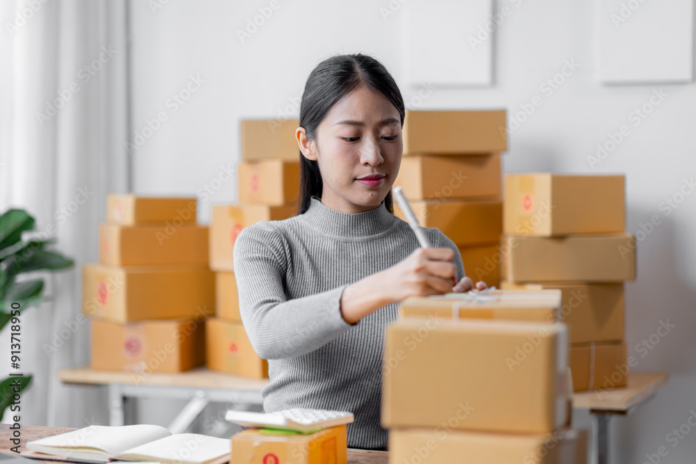 Attractive young freelancer SME owners asian woman entrepreneurs working on receipt box and check online orders, SME home business ideas online. Attractive young freelancer SME owners asian woman entrepreneurs working on receipt box and check online orders, SME home business ideas online.