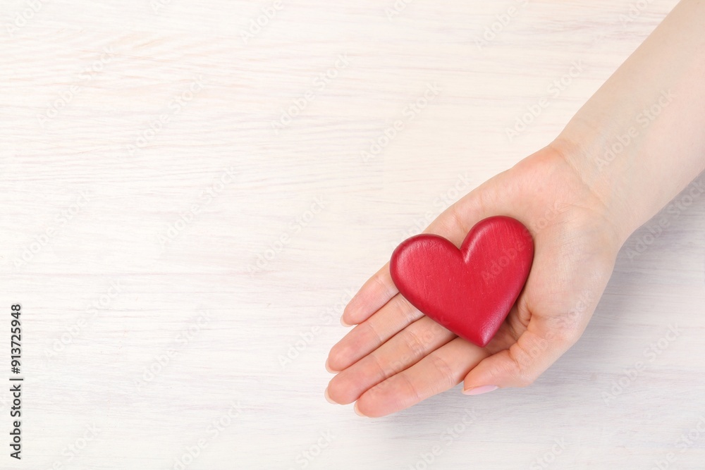 Woman with red decorative heart at white wooden table, top view. Space for text Woman with red decorative heart at white wooden table, top view. Space for text
