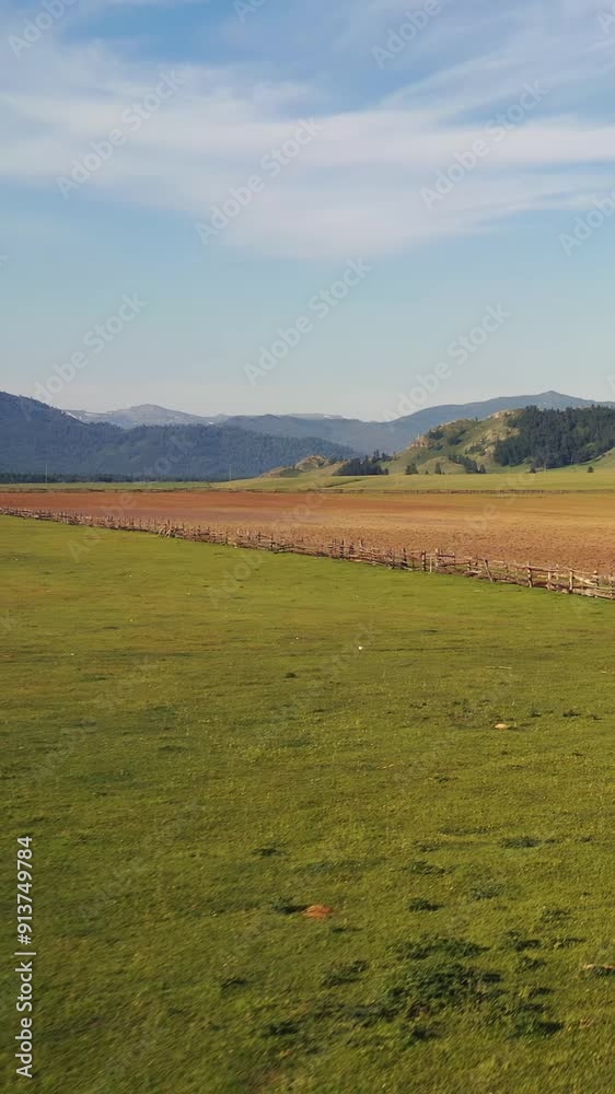 Vertical video of Altai rural landscape. Wooden fence in the foreground. Vertical video of Altai rural landscape. Wooden fence in the foreground.