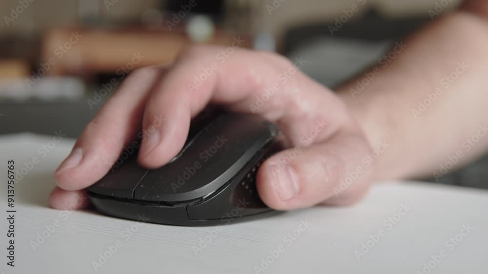 European man scrolls wheel of wireless black mouse closeup. Controlling computer peripherals and scrolling through pages and documents to search for information on computer. European man scrolls wheel of wireless black mouse closeup. Controlling computer peripherals and scrolling through pages and documents to search for information on computer.