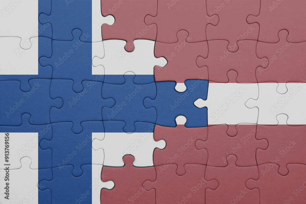 puzzle with the colourful national flag of latvia and flag of finland. puzzle with the colourful national flag of latvia and flag of finland.