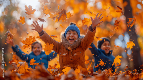 Fototapeta Naklejka Na Ścianę i Meble -  Children joyfully playing and throwing autumn leaves in a vibrant fall forest