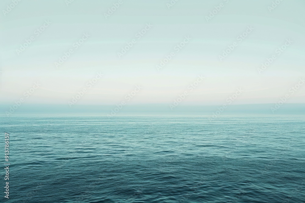 Obraz premium A minimalist seascape with an expansive horizon stretching towards infinity. The image captures the vastness of the open ocean, utilizing calming tones and soft gradients reminiscent of the seascapes
