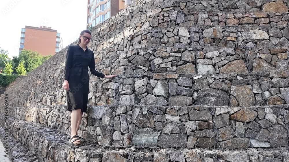 Woman walking in the city wearing elegant black dress Woman walking in the city wearing elegant black dress
