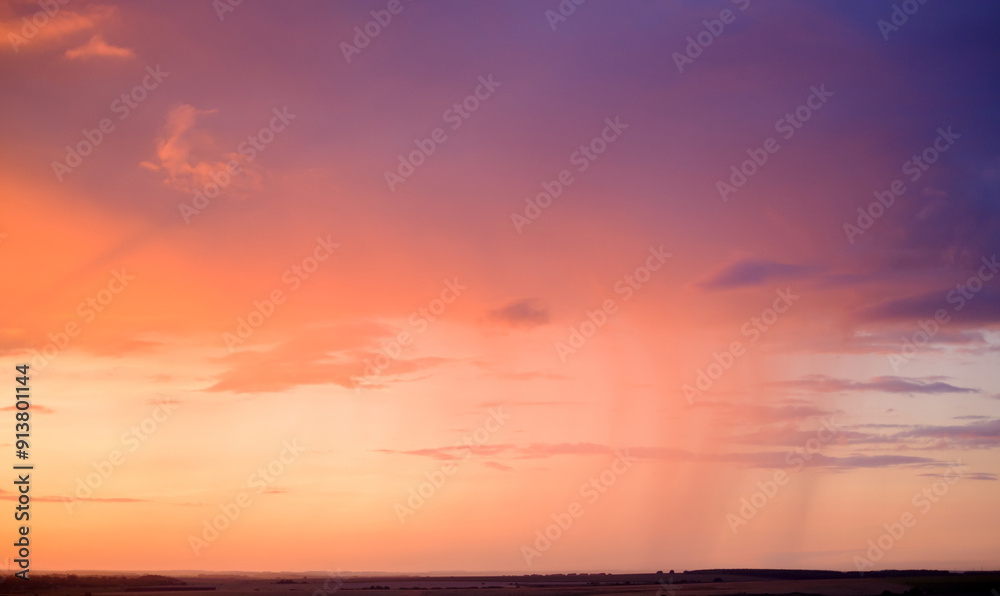 Obraz premium evening violet-orange sky over fields on the horizon
