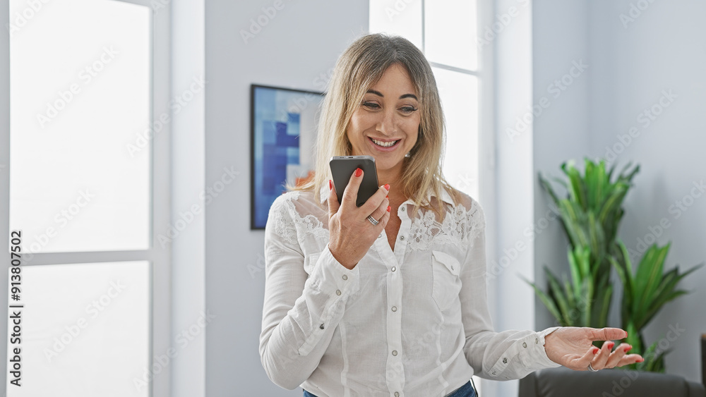 Smiling caucasian businesswoman using smartphone in modern office setting, conveying connectivity and professionalism. Smiling caucasian businesswoman using smartphone in modern office setting, conveying connectivity and professionalism.