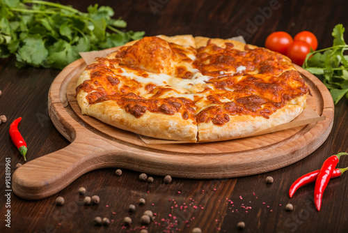 khachapuri with sulguni cheese, herbs and egg on a wooden surface. Georgian pie. Georgian pizza
 photo