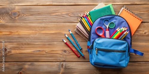 close up top view of school bag and supplies