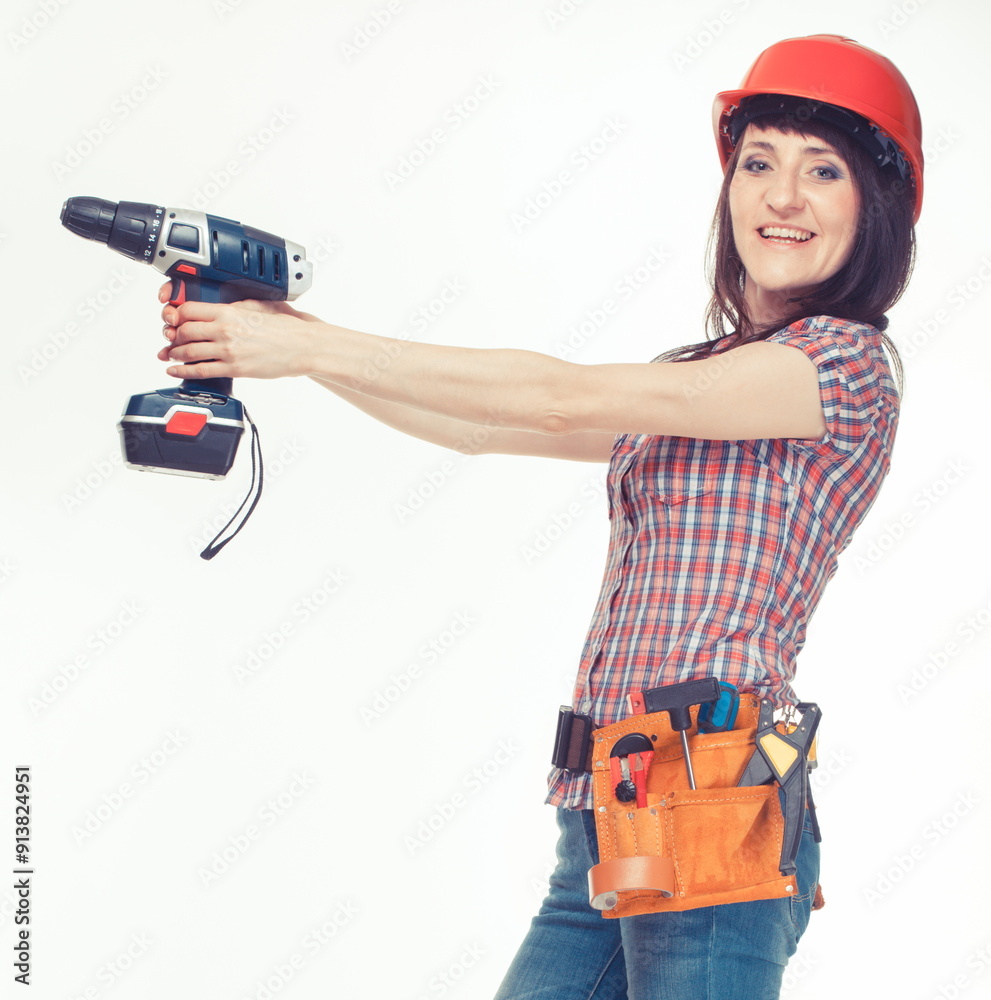 Woman engineer in red helmet with cordless screwdriver or drill and tools used for various jobs. Engineering Woman engineer in red helmet with cordless screwdriver or drill and tools used for various jobs. Engineering