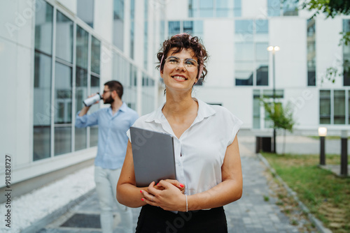 Two smiling business people going to work to modern business building