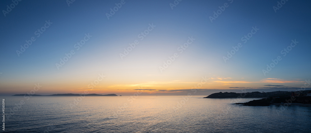 Obraz premium Sunset falling over Ons Island in Galicia, Spain, as seen from the air.