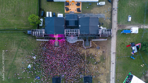 Drone photography of a music stage and concert at a festival during summer evening
