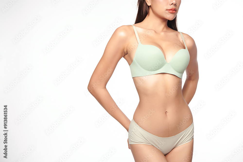 Naklejka premium Confident beautiful young asian woman posing in green lingerie on white background, Perfect body,