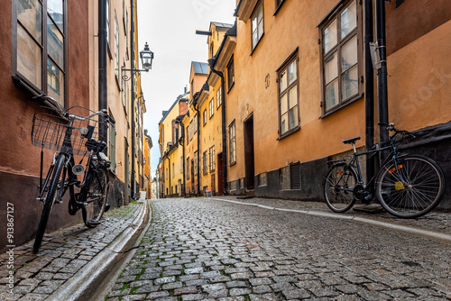 Sweden quaint cobblestone street in picturesque Gamla Stan, Stockholm's oldest neighborhood. Parked bicycles lean against the colorful plaster buildings. photo